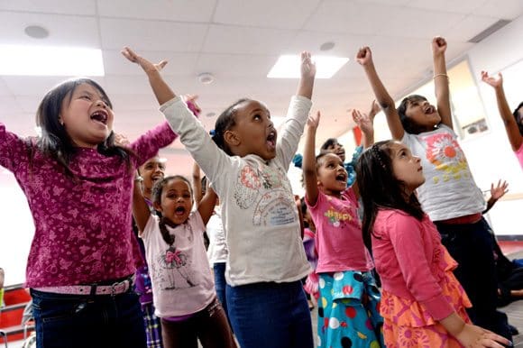 Kids jumping with their arms raised